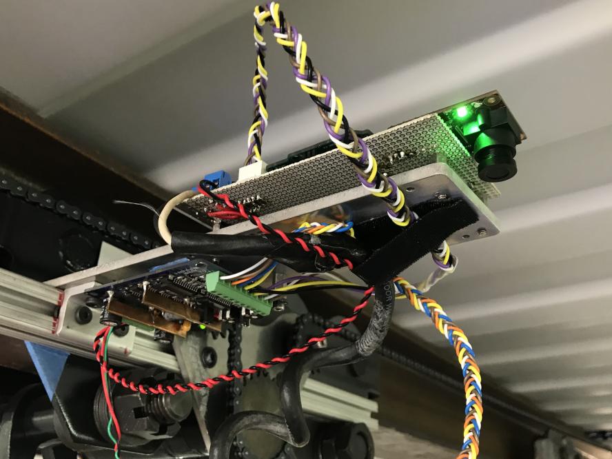 Figure 3: On the right is the camera that detects RoboSimians position which is fed back into the controller. Also visible are supporting electronic and the mechanical system in the back.